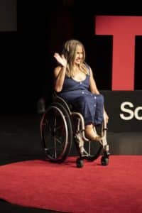 Alycia Anderson on stage speaking at TEDx.